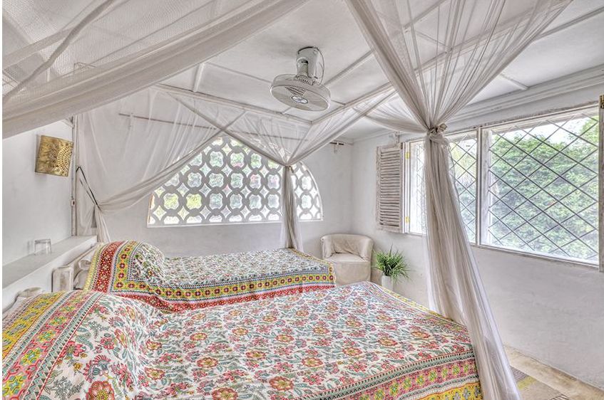Bedroom 2 with two beds in floral block-print covers