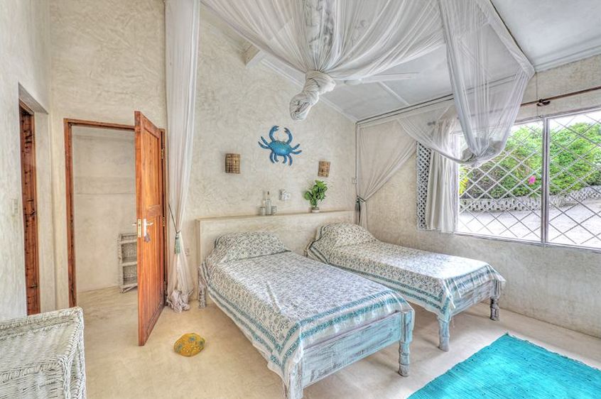 Bedroom 4 with twin beds and crab wall decorations