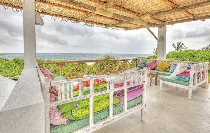 Covered rooftop view deck with sofas and ocean view